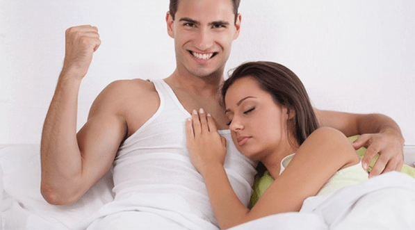 a woman in bed with a man who increases strength